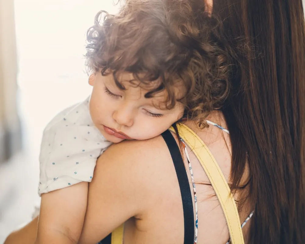 4 year old sleeping with head on mom's shoulder