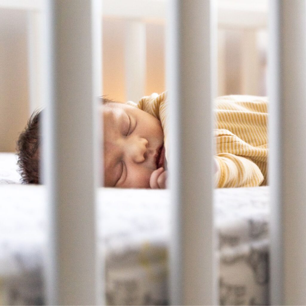 Baby sleeping comfortably in crib