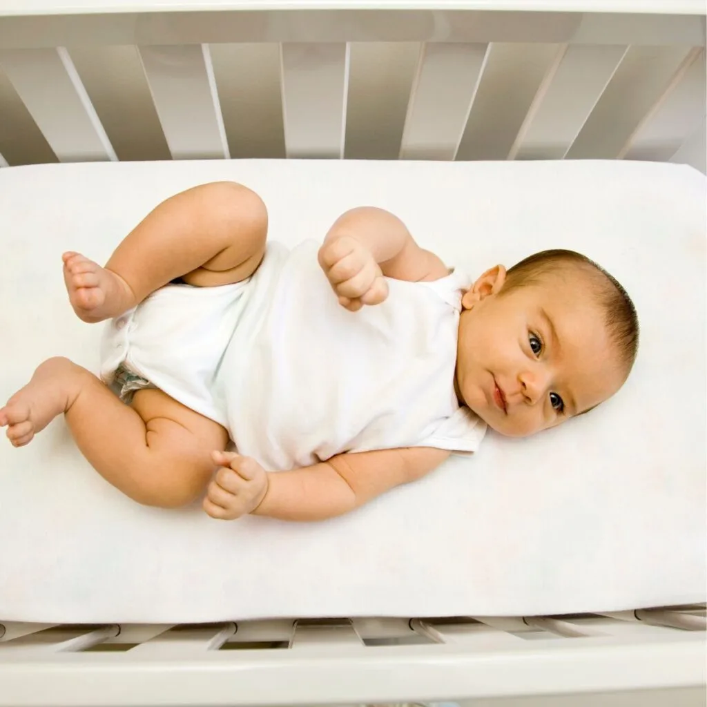 baby laying in crib sleep training