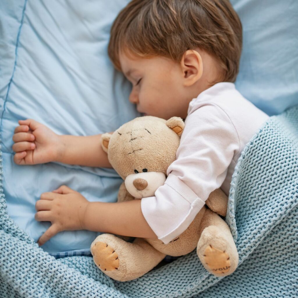 Toddler boy cozy in bed. 