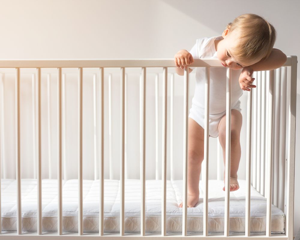 11 month old baby standing in crib