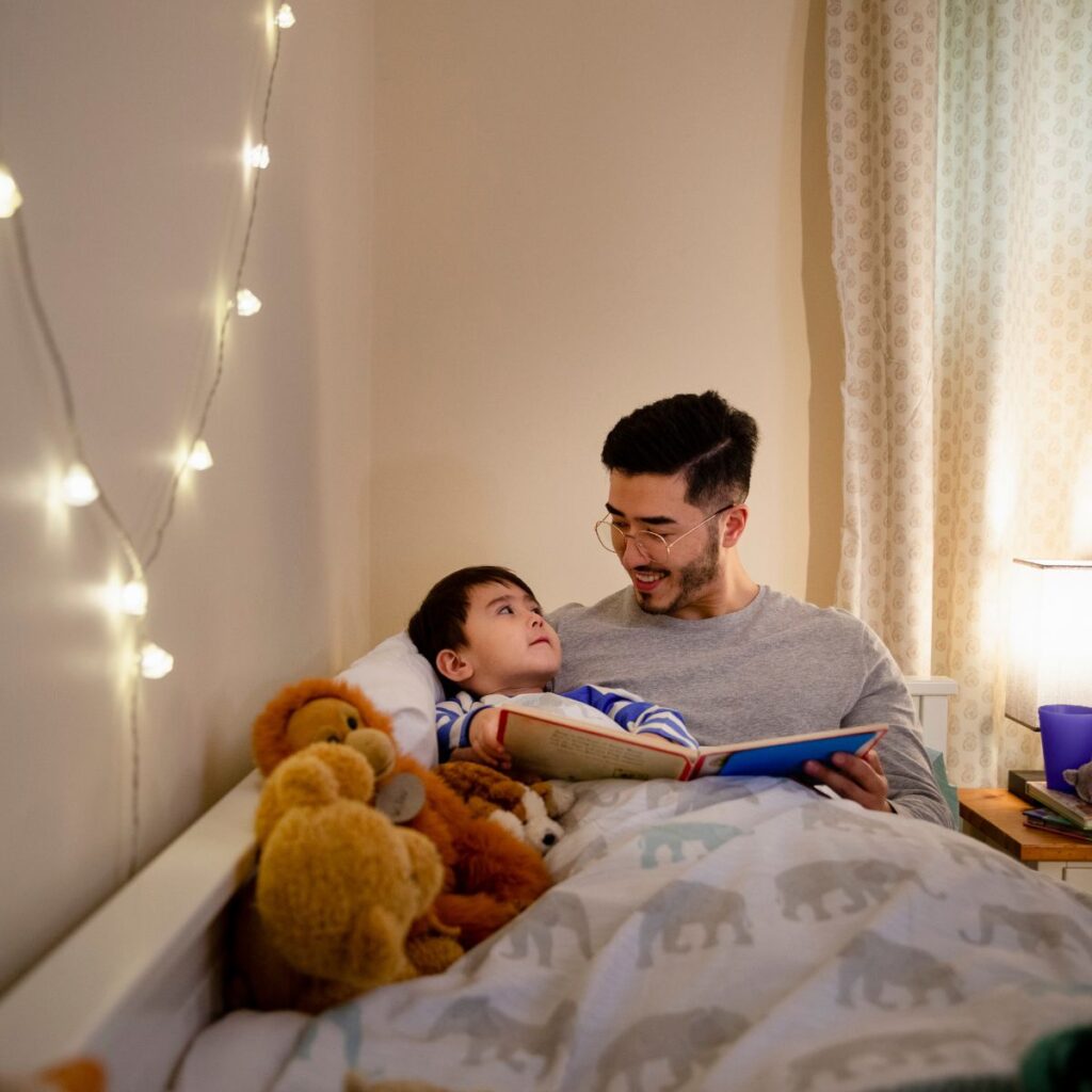 Dad reading to toddler at bedtime