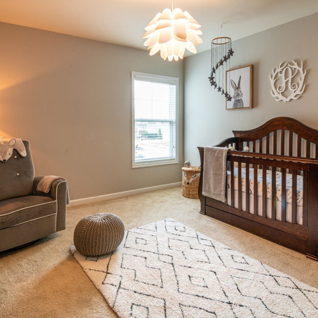 baby's nursery with crib and glider