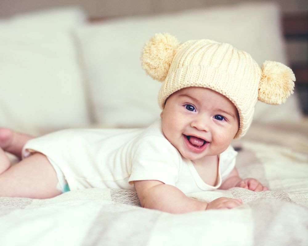 image of smiling baby wearing a winter hat