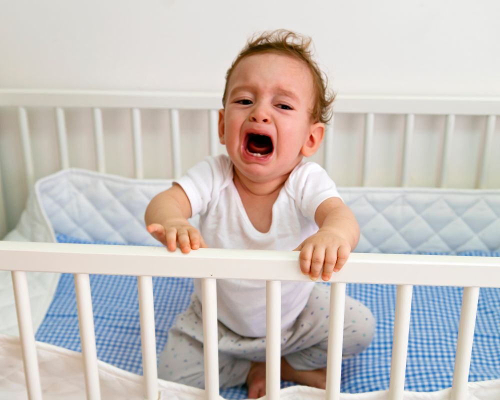 image of baby crying in crib