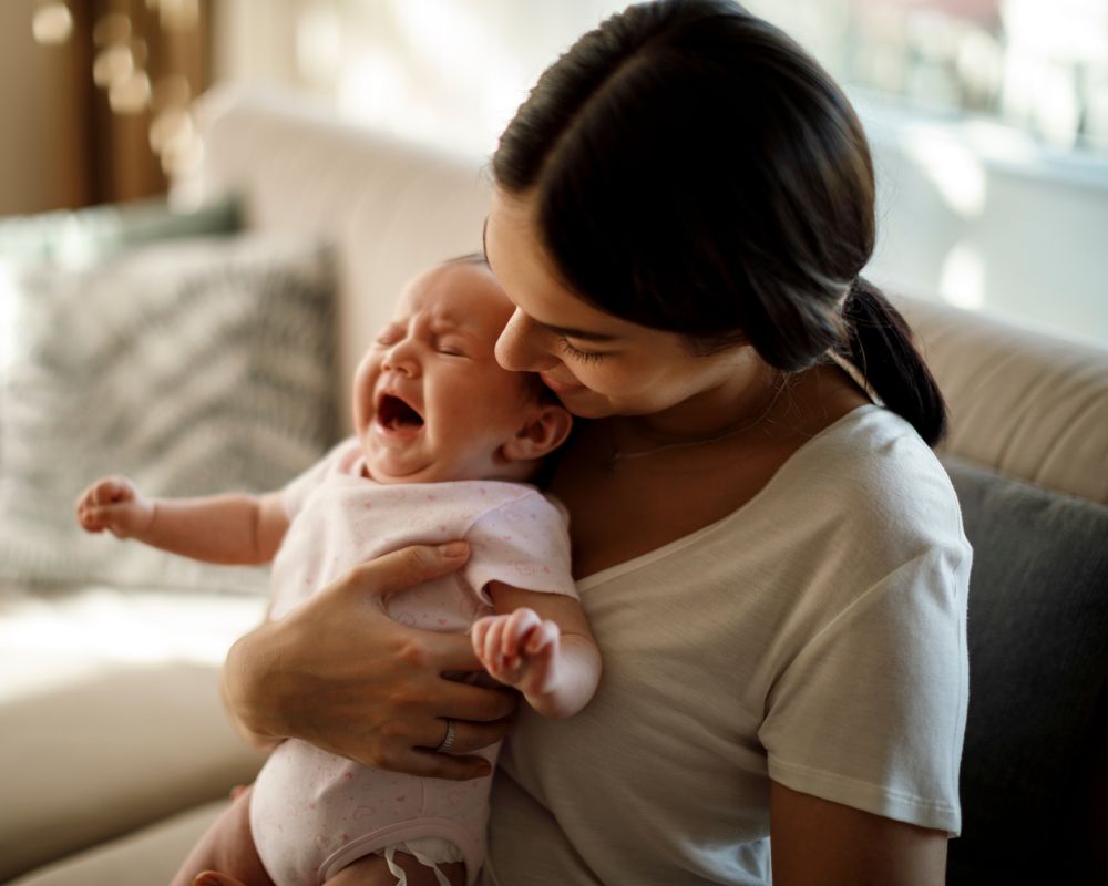 image of mom holding crying baby