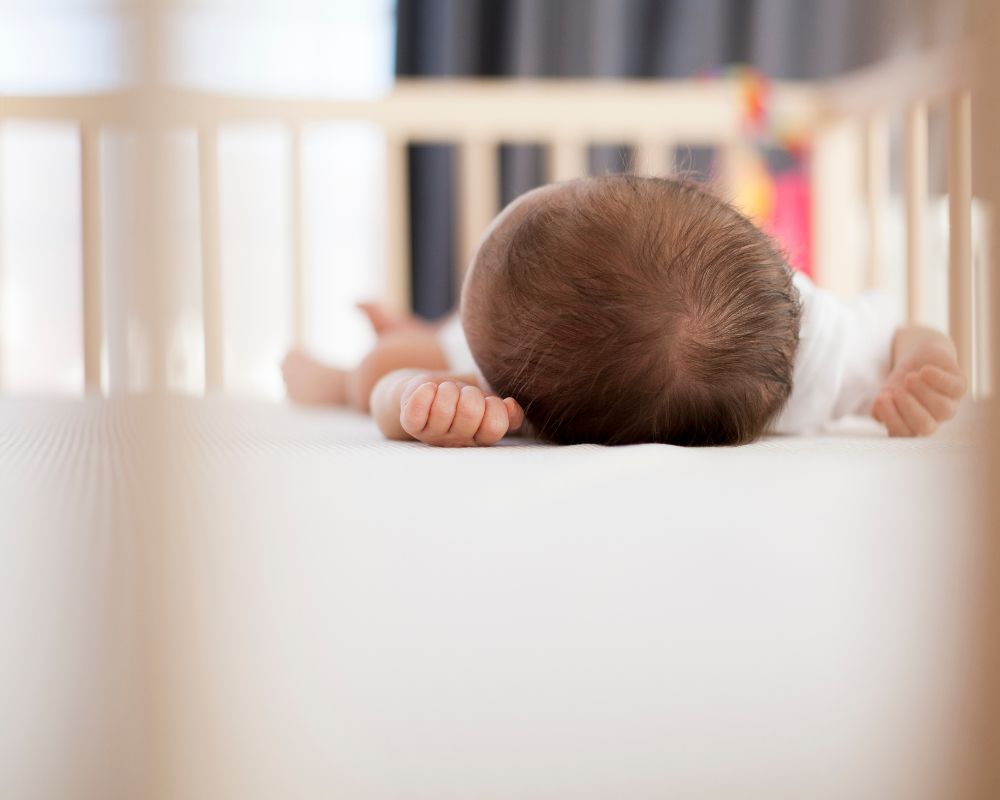 image of baby asleep in the crib