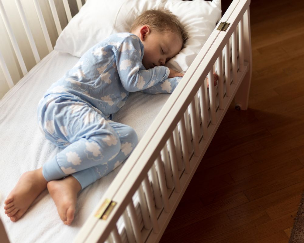 image of toddler sleeping in toddler bed during nap time
