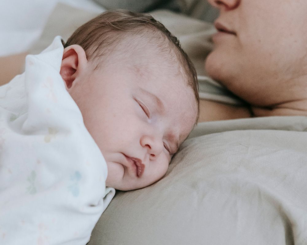 baby taking contact nap on mom's chest