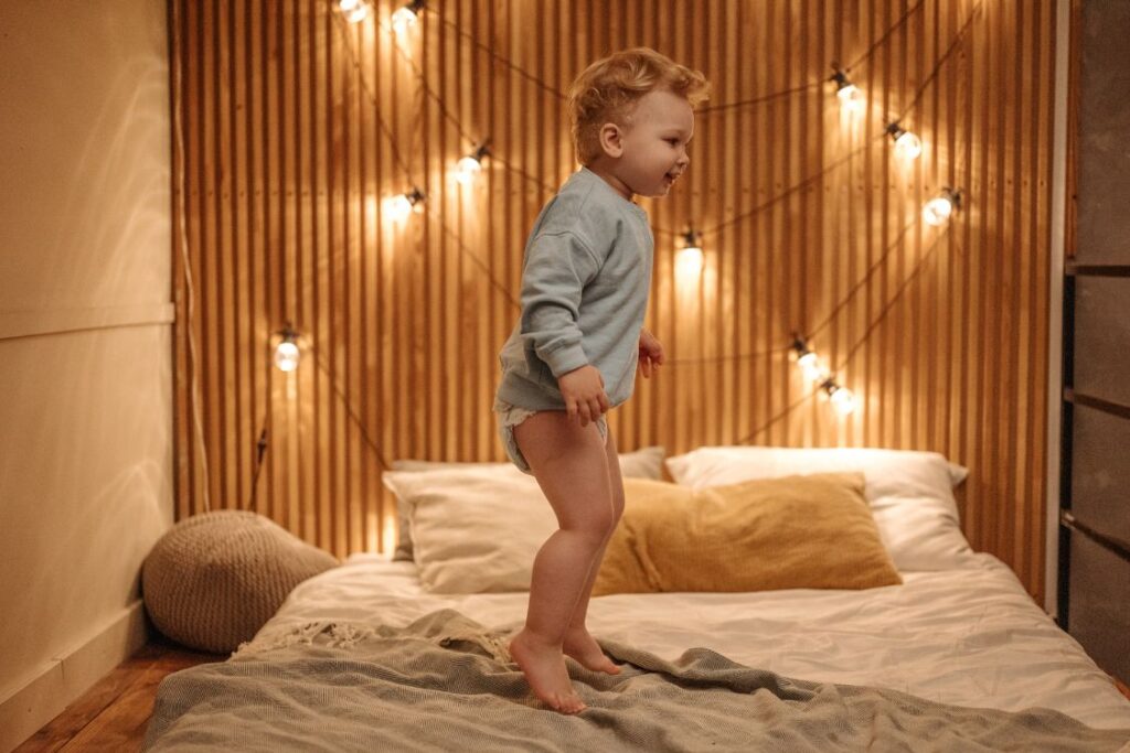 toddler awake jumping on bed