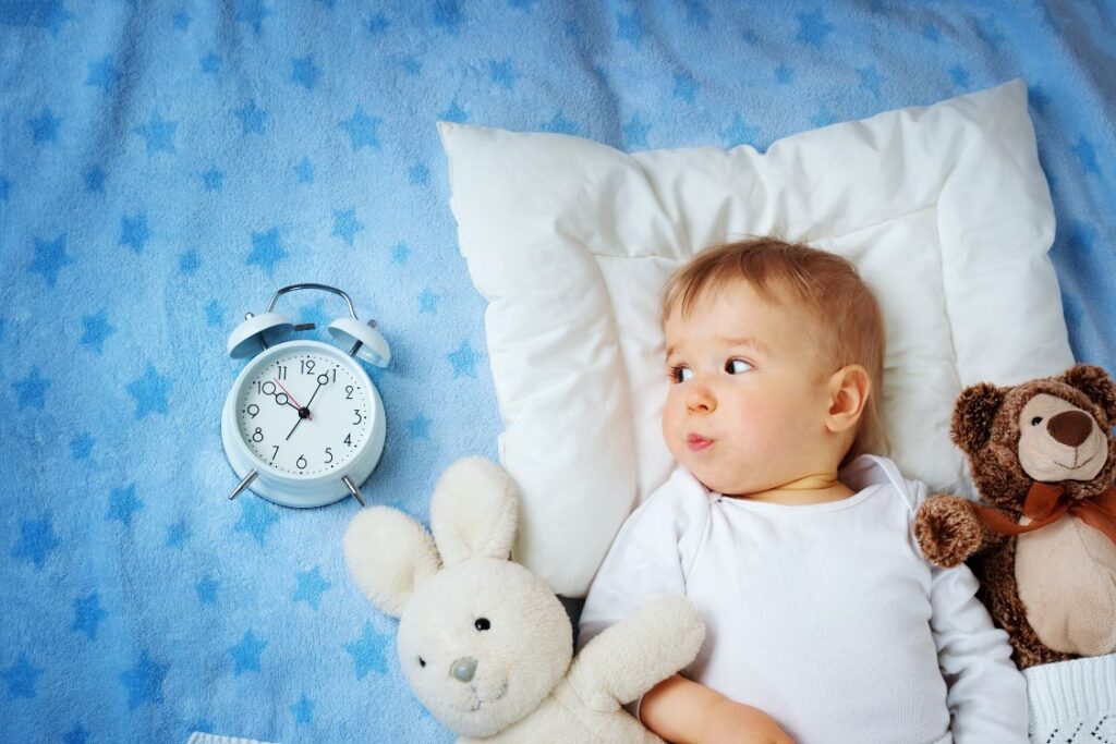little boy in bed looking at clock