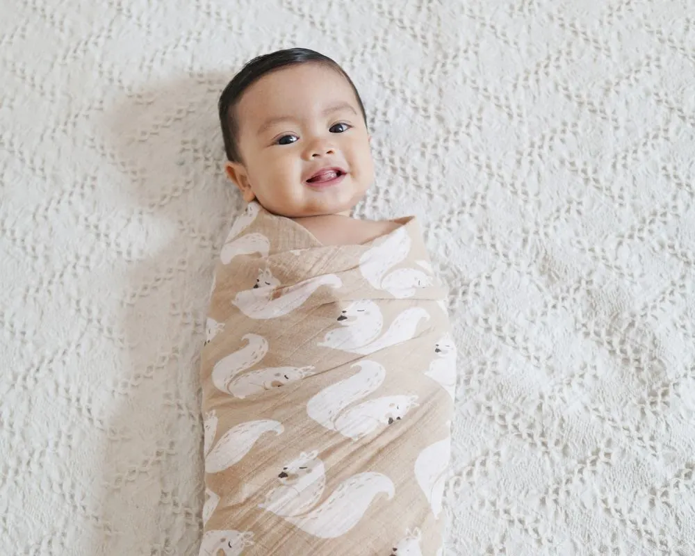 baby swaddled and smiling
