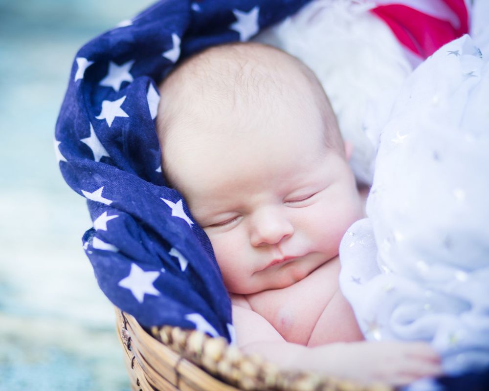 baby sleeping on an American flag