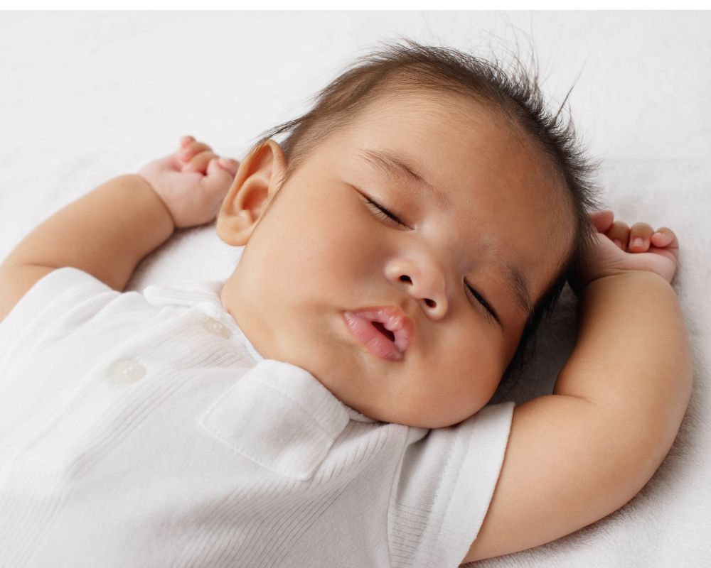 baby sleeping with arms out with no swaddle