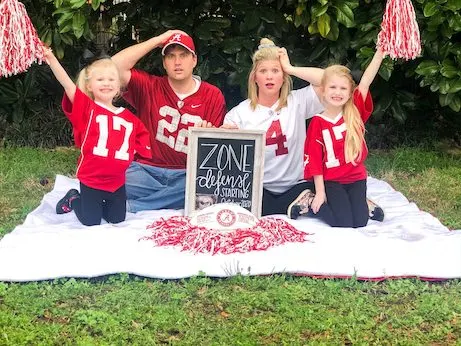 family dressed up as football players to announce pregnancy