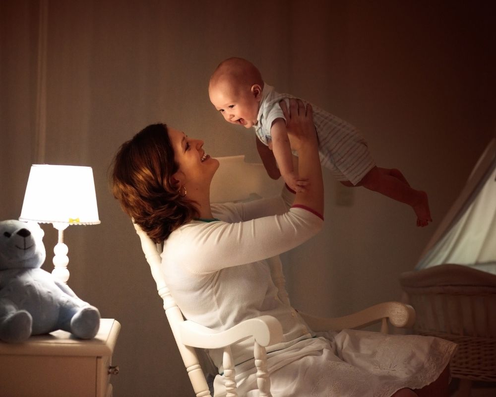 mom holding baby at night getting ready for bed